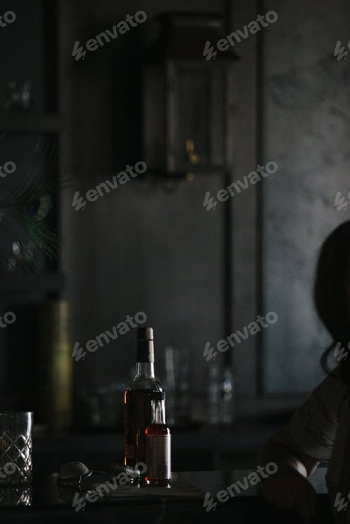 Preview: An empty table witha bottle of wine and glasses.
