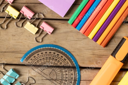 Preview: Composition of colorful crayons, pins and protractor on wooden background