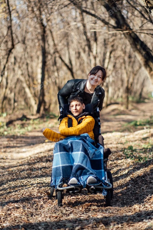 Preview: Mother and child with special needs enjoying nature walk in forest, accessibility in outdoor