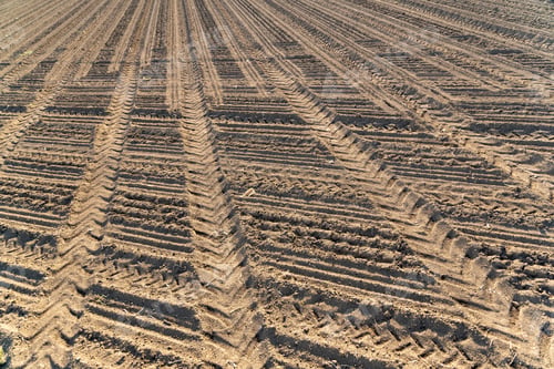 Preview: Plowed field brown soil tractor tracks