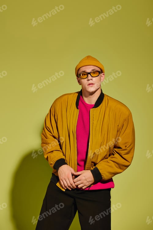 Preview: Fashion model showcasing trendy and stylish attire in a vibrant studio setting