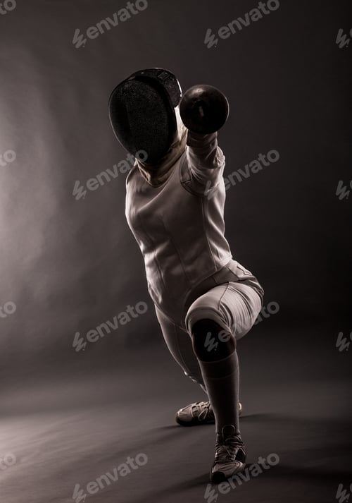 Preview: Portrait of woman wearing white fencing costume practicing with the sword.