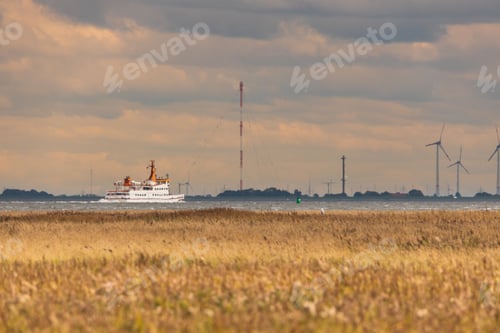 Preview: Beautiful view of a beach and sailing ship in Langeoog, Northern Germany