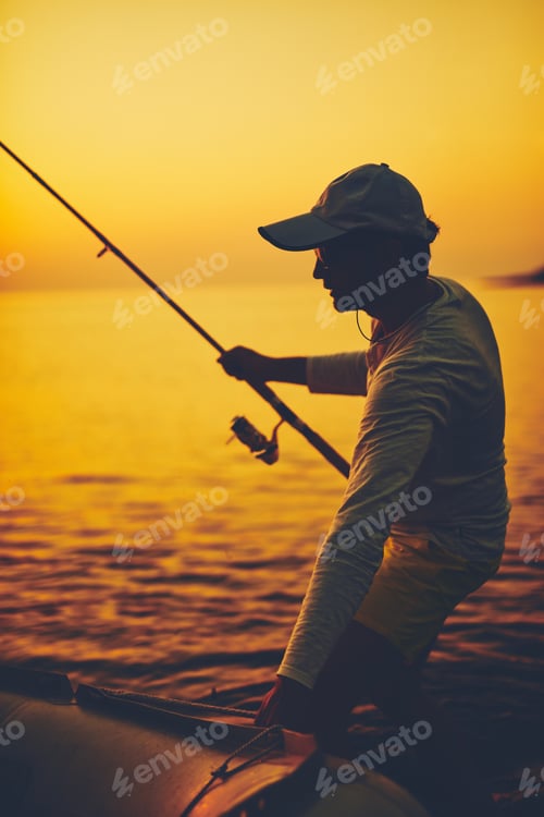 Preview: Silhouette Of A Fisherman Fishing In Sunset Time On The Open Sea.