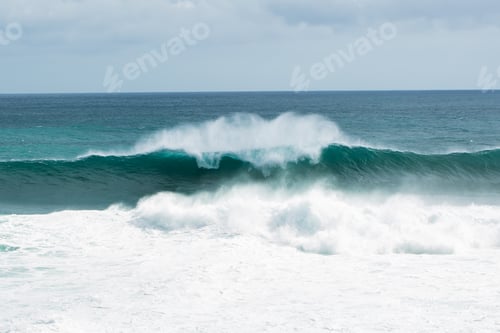 Preview: view from the beach to a tropical island and some granite rocks in the sea
