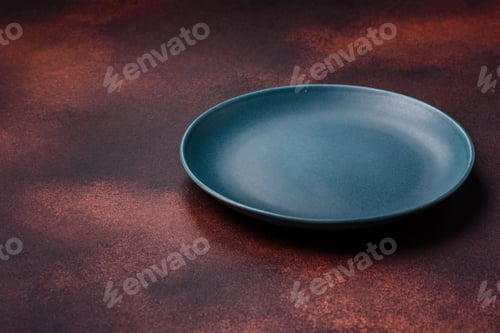 Preview: Empty ceramic round plate on dark textured concrete background