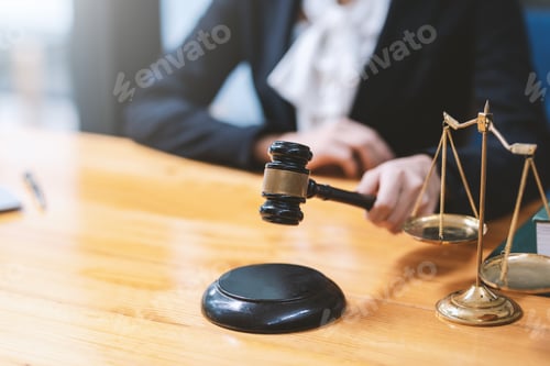 Preview: Close-up of a lawyer or businesswoman holding a mallet working at the office.