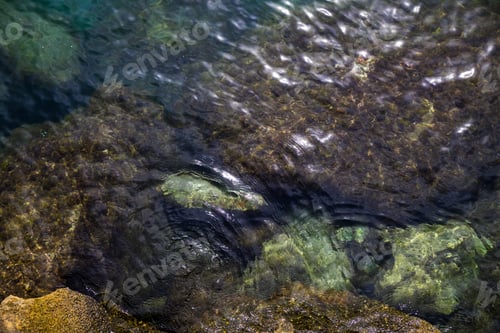 Preview: Top view on sea water with underwater stones, nature background