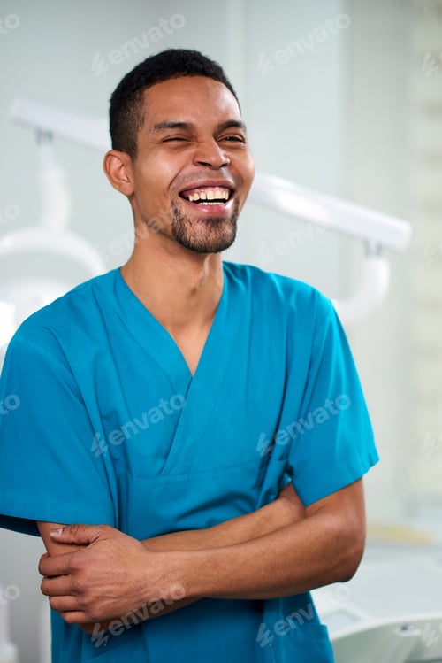 Preview: African male dentist looking towards camera and smiling