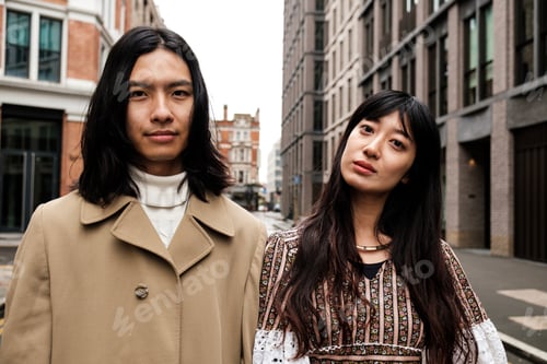 Preview: Young fashionable asian couple posing in london street