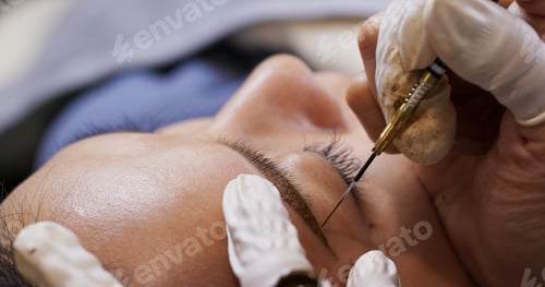 Preview: Young woman gets facial beauty procedure, microblading procedure on woman eye at beauty salon