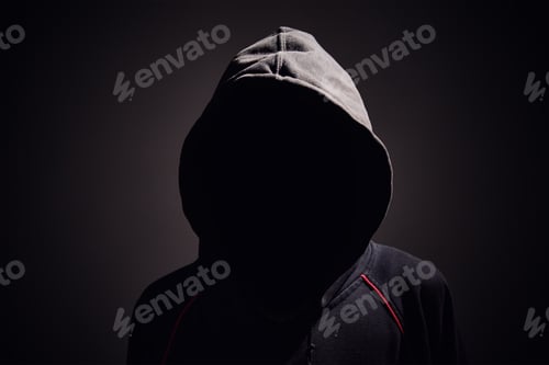 Preview: Silhouette af man without face in hood on black background. Anonymous crime concept
