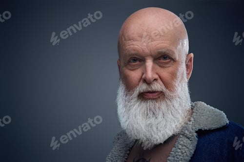 Preview: Bald elderly man with long gray beard against gray background