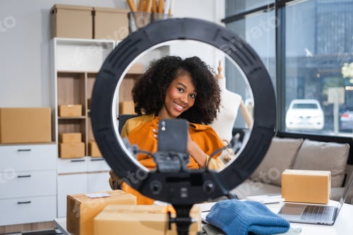 Preview: A young African American woman with afro brown hair works in modern office, management clothing