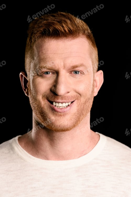 Preview: portrait of handsome redhead man smiling isolated on black