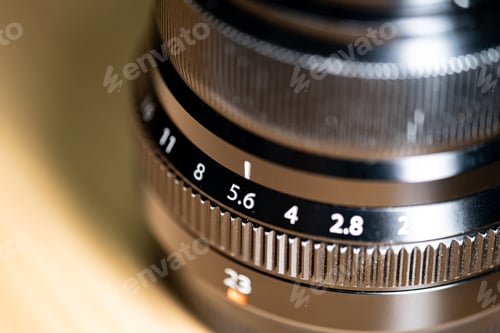 Preview: Close-up of camera lens with aperture and focal length markings