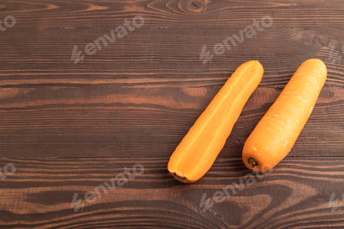 Preview: Orange Carrot on brown wooden, Side view, copy space