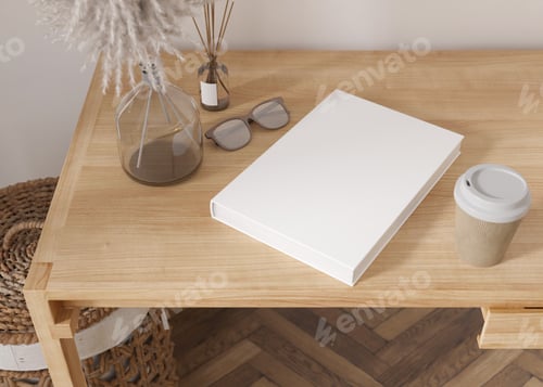 Preview: White book cover mock up with coffee cup, vase and other home accessories on wooden table.