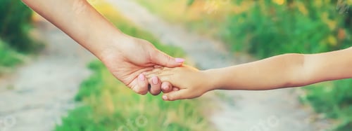 Preview: mother and child go by the hand. Selective focus.