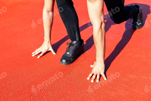 Preview: hands of unrecognizable male runner ready to run