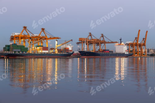 Preview: Cargo ships dock at a busy port terminal alongside towering yellow gantry cranes