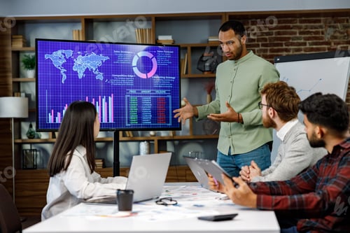 Preview: Motivated african american businessman having business meeting with managers, negotiating, using