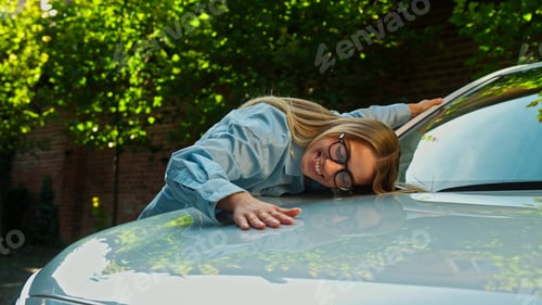Preview: Happy Caucasian woman businesswoman hugging kiss new car automobile purchase client buyer dream girl