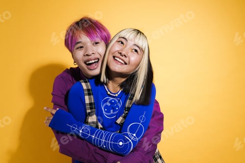 Preview: Asian couple with multicolored hair hugging and laughing together