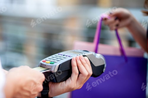 Preview: Woman payment via credit card swipe machine.