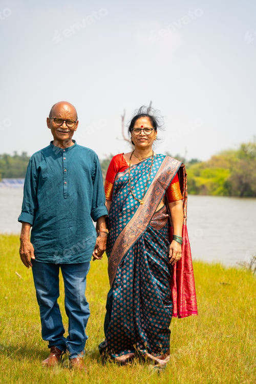 Preview: Happy Indian senior couple near river