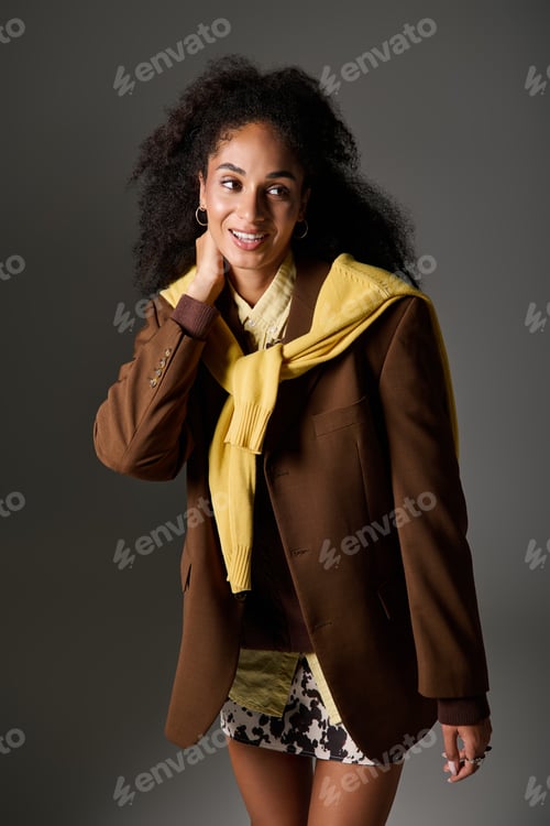Preview: Stunning African American woman showcases trendy autumn fashion in studio setting