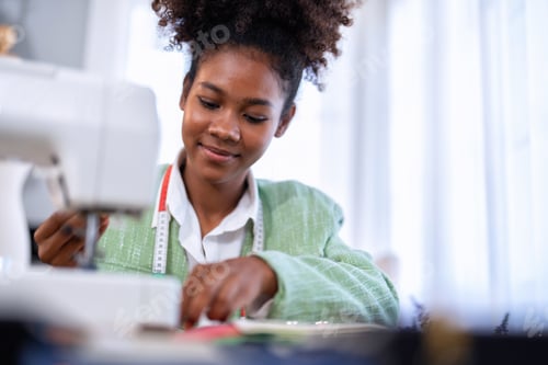 Preview: Stylish fashionable clothes designer girl at a sewing machine design clothes tailoring studio room