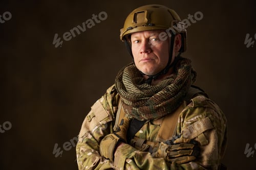 Preview: portrait of an airsoft soldier in camouflage clothing with arms crossed