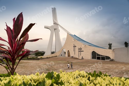 Preview: A serene moment as visitors approach a modern church at dusk