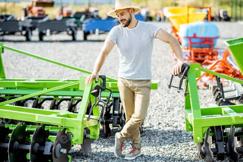 Preview: Agronomist at the shop ground with agricultural machinery