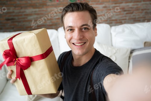 Visualização: Homem segurando uma caixa de presente, comemore a festa de Natal, Feliz Ano Novo.