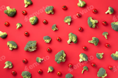 Preview: Creative layout of green broccoli, tomatoes on red paper background. Top view. Food pattern in