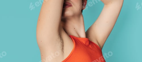 Preview: An unshaven young woman flaunting her unshaven armpits. Panoramic banner. Body positive young woman