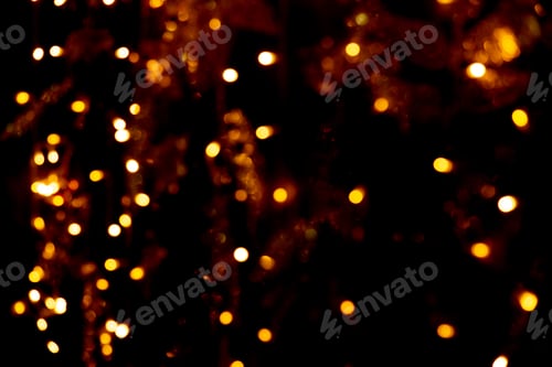Preview: Blurry garland lights on a dark background. Festive Christmas and New Year background. Soft focus
