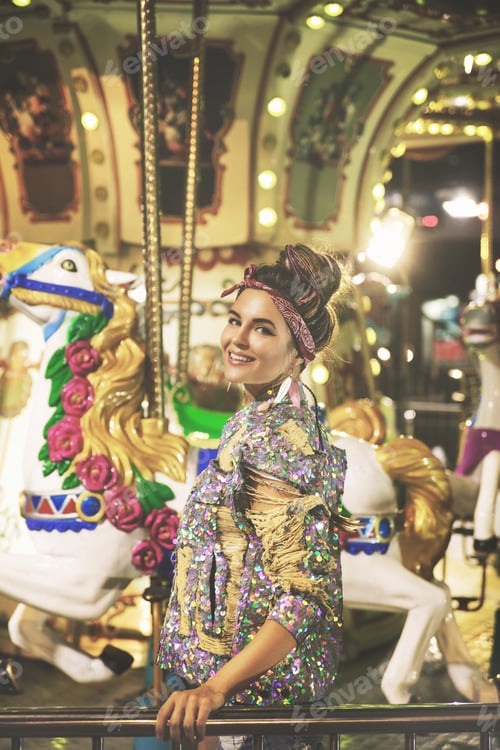 Preview: Stylish woman wearing sparkling jacket on the carousel