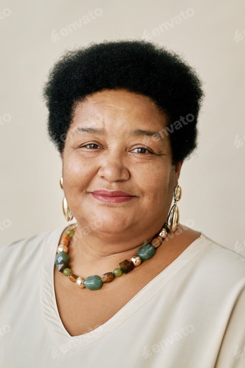 Preview: Portrait of Smiling Middle Aged Woman Wearing Beaded Necklace in Studio