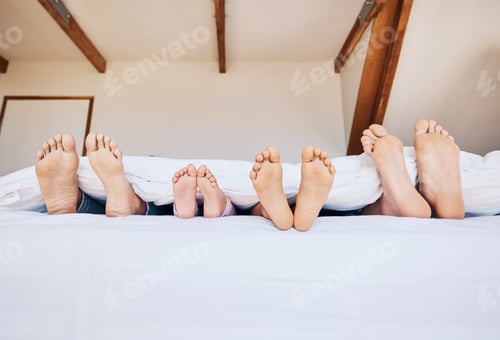 Preview: Family, morning and feet in bed to relax together closeup in their home on the weekend with mockup.