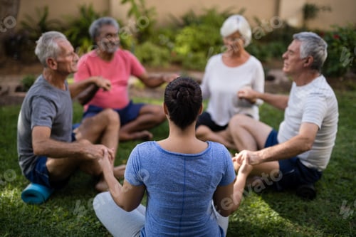 Preview: Group of people meditating together in a garden