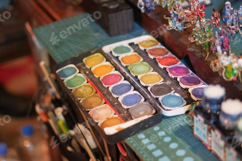 Preview: Paints and paint brushes in an artists studio.