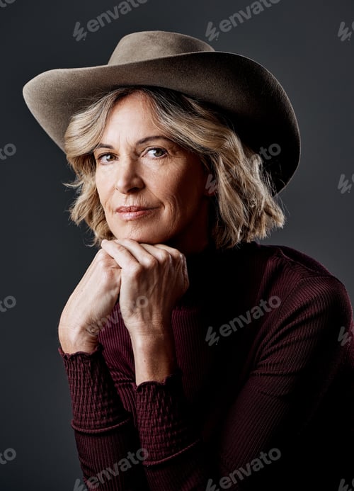 Preview: Cropped shot of a mature woman looking stylish against a grey background