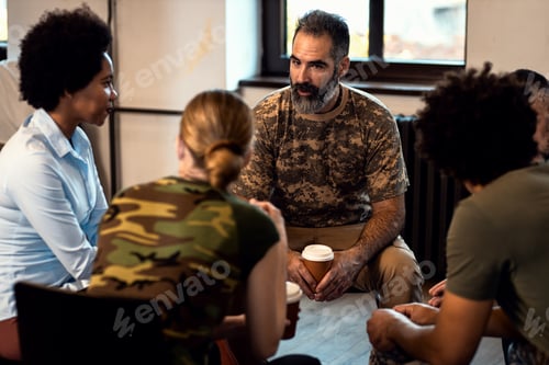 Preview: Group of diverse veterans talking during PTSD support group.