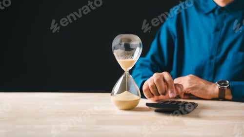 Preview: Hourglass sand flowing, tax payment deadline approaching, business person calculates corporate