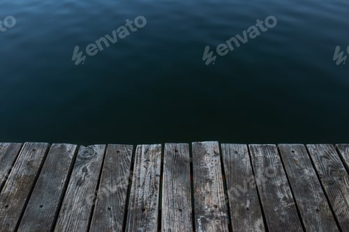 Preview: Wooden boards and water, masonry on the lake close-up.