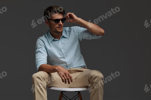 Preview: Young european business man sitting on chair
