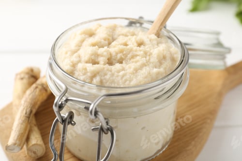 Preview: Tasty horseradish sauce and roots on white wooden table, closeup